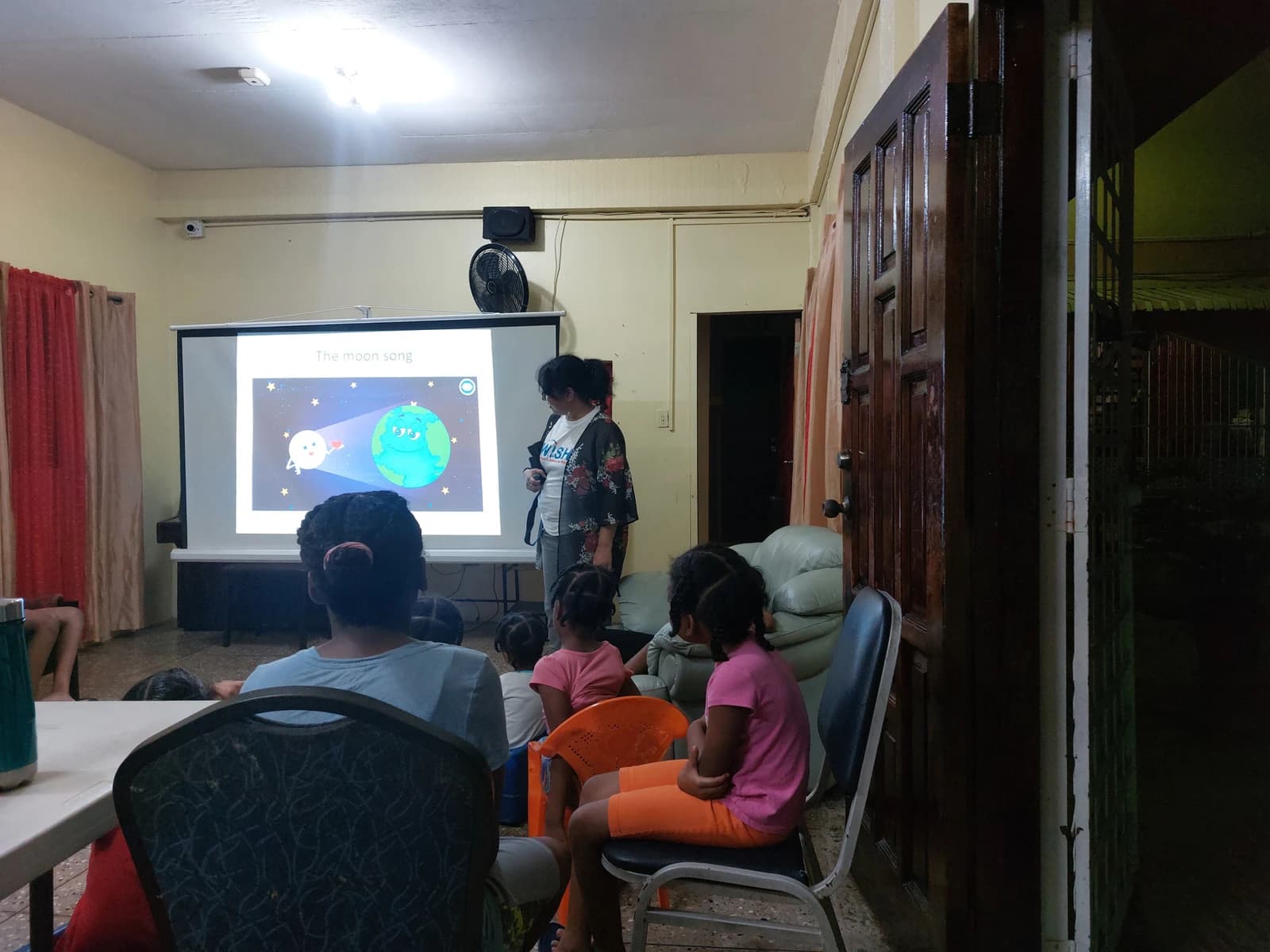 Children watching a WISH astronomy presentation about the Moon