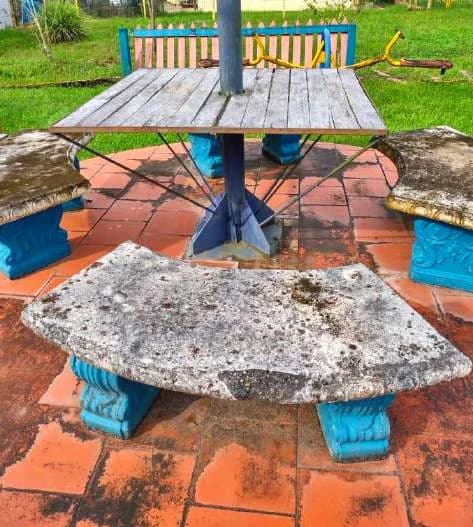 Damaged tables and worn paint before the park renovation